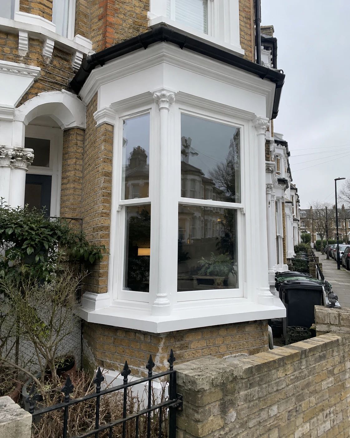 White double glazed timber sash bay window with traditional period detailing