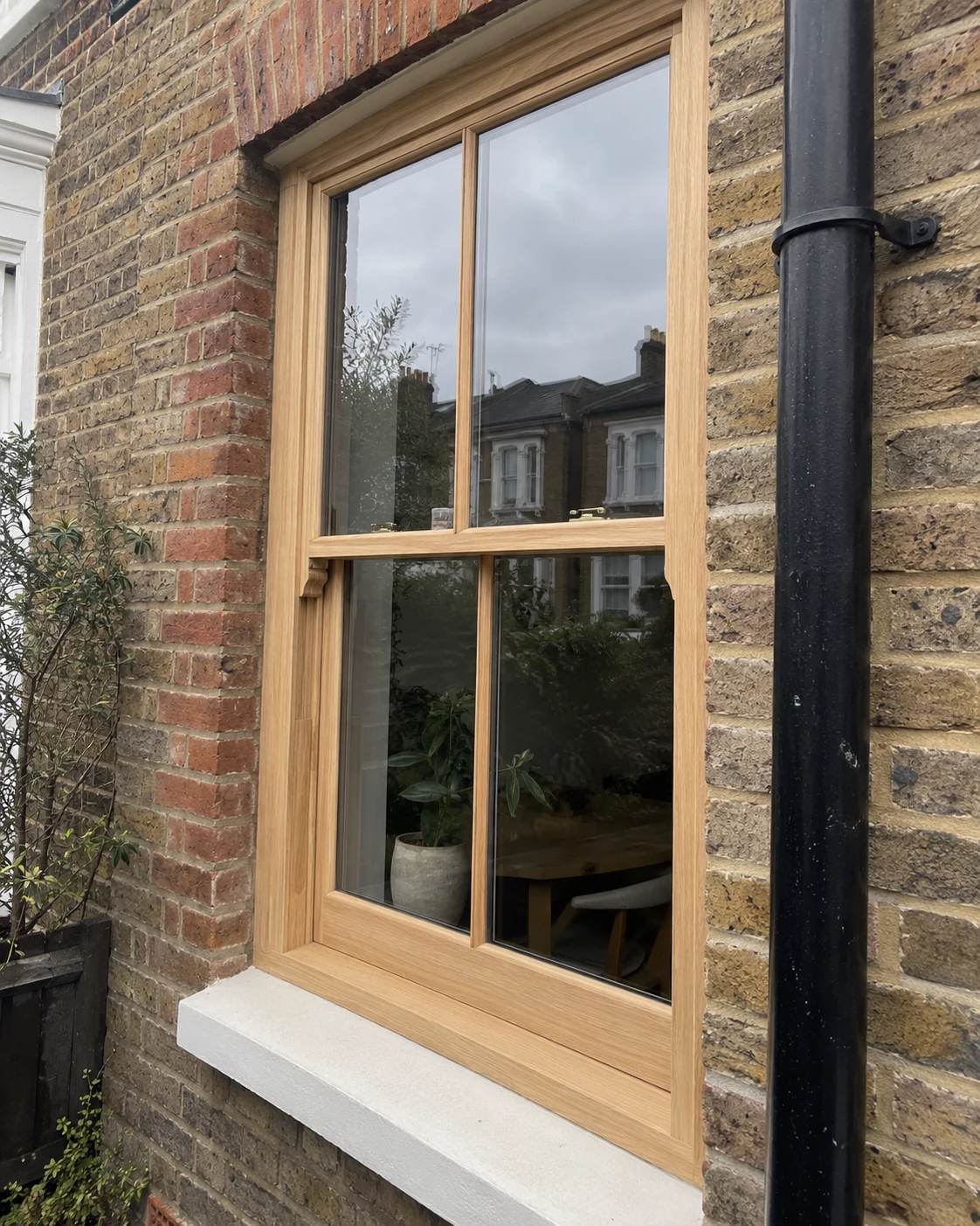 Natural timber sash window showing carefully made hardwood joinery and glazing details