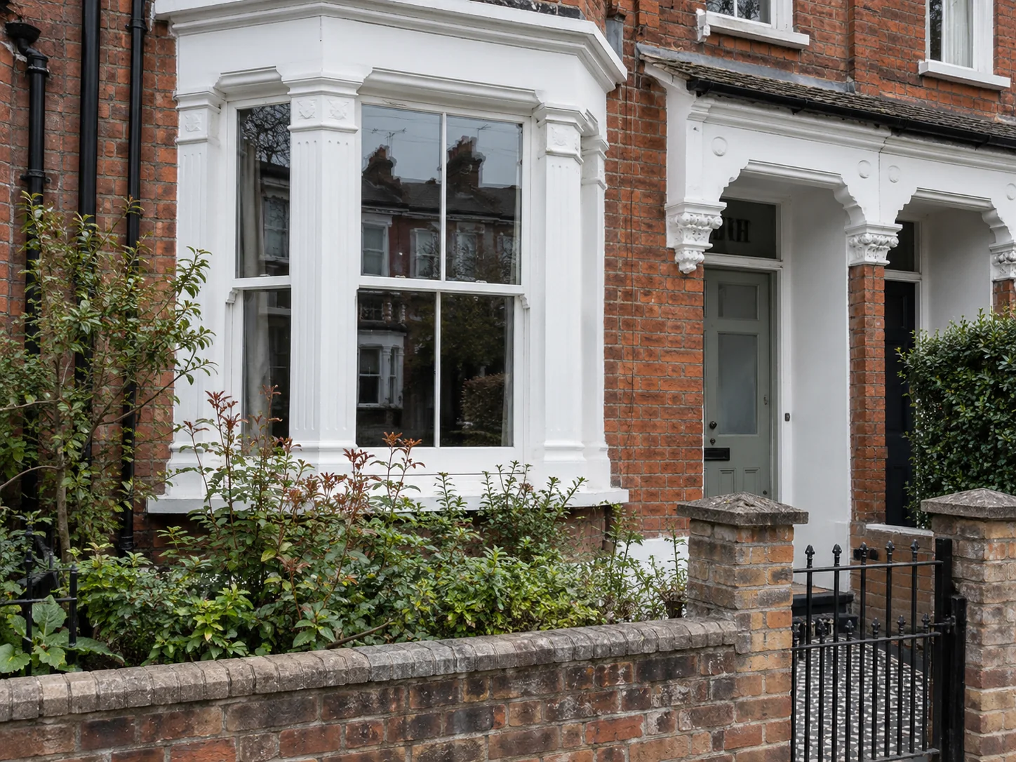 Traditional terraced property with a prominent timber sash bay window