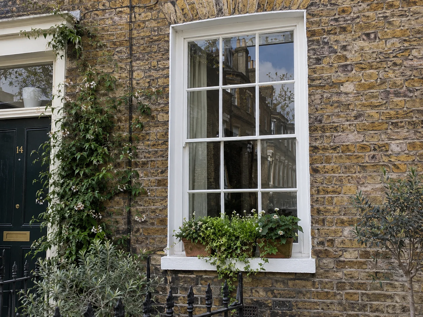 Traditional sash window set in brickwork with a flower box